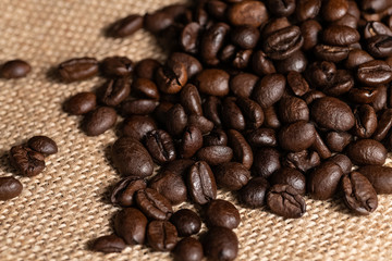 close-up of roasted coffee beans lying on canvas