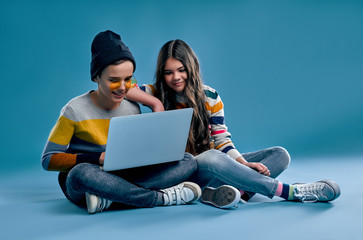 Fashionable boy and cute girl on a blue background
