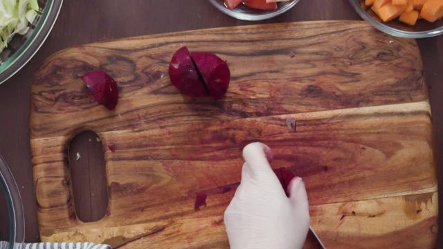 Step by step. Flat lay. Slicing beetroot into the small cubes for beet soup, borscht.