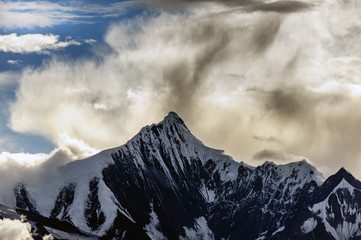 Snow Capped Peak of Kawagarbo or Kawa Karpo (also transcribed as Kawadgarbo, Khawakarpo, Moirig Kawagarbo, Kha-Kar-Po or Kawagebo Peak) under a cloudy stormy sky between Yunnan and Tibet, China