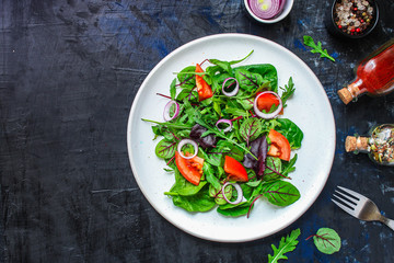 healthy salad (tomato, mix leaves, onions and other ingredients) vegan top menu concept. food background. copy space