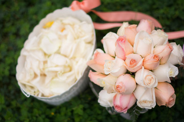 Bouquet and bucket of rose petals