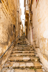 Fototapeta na wymiar stairs in narrow street in Malta