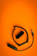 Black fitness watch (activity tracker) on a smartphone, health-saving technologies, modern technology concept, flat lay style place for text