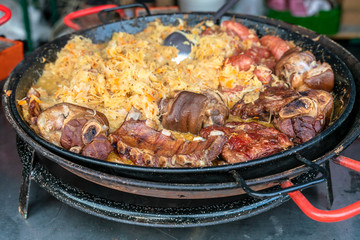 Traditional street food. Fried pork and stewed cabbage.