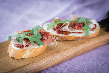 Bruschetta with tomato and basil, bruscetta with salmon and eggs, bruscetta with prosceutto and rucola