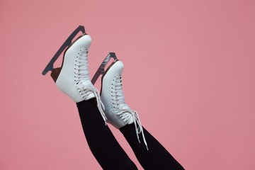 Figure skating is a winter sport and leisure. Women's feet in ice dancing skates.