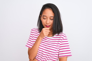 Young chinese woman wearing striped t-shirt standing over isolated white background feeling unwell and coughing as symptom for cold or bronchitis. Healthcare concept.