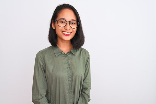 Young Chinese Woman Wearing Green Shirt And Glasses Over Isolated White Background With A Happy And Cool Smile On Face. Lucky Person.