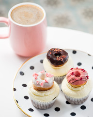 cupcakes with icing and small decorative donuts