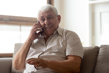 Happy elderly man talk using modern smartphone gadget