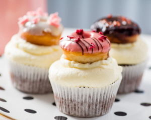 cupcakes with icing and small decorative donuts
