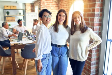 Beautiful businesswomen smiling happy. Standing with smile on face speaking taking rest at the office