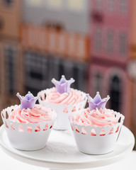 cupcakes with rose ice and a decorative marzepan crown