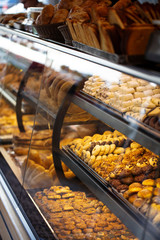 Different types of cakes in pastry shop glass display