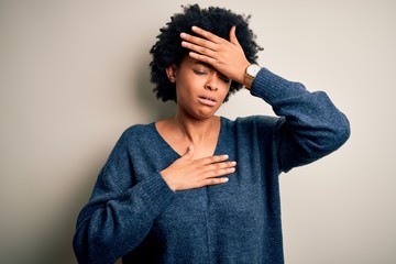 Young beautiful African American afro woman with curly hair wearing casual sweater Touching forehead for illness and fever, flu and cold, virus sick