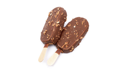 Chocolate ice cream with nuts on a stick. Isolated on a white background. Tasty dessert.