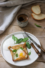 Breton buckwheat crepes with egg, spinach and cream, filed with the coffee. Rustic style.
