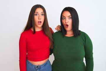 Young beautiful women wearing casual clothes standing over isolated white background afraid and shocked with surprise expression, fear and excited face.