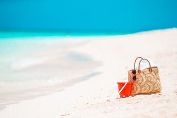 Fototapeta na wymiar Beach accessories - straw bag, hat and unglasses on the beach