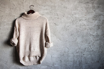 Beige Warm Long Sleeve Shirt on Black Hanger Hang on gray background