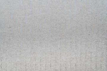 Light gray surface from sheet of recycled carton. Close-up detail macrophotography view of abstract texture recycled eco-friendly cardboard material pattern background.
