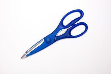 Blue kitchen scissors close up on white background