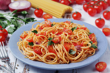 A plate with spaghetti with tomatoes	