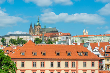 Obraz premium Top view to red roofs and blue sky skyline of Prague city Czech republic.
