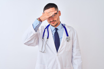 Young doctor man wearing stethoscope over isolated background covering eyes with hand, looking serious and sad. Sightless, hiding and rejection concept