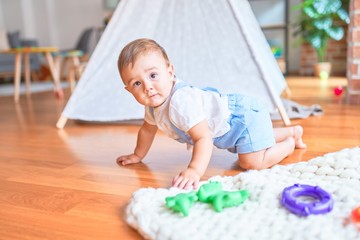 Beautiful toddler crawling at kindergarten