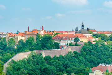 Top view to red roofs and green trees skyline of Prague city Czech republic. © karamysh