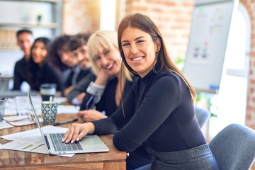 Group of business workers sitting in line with smile on face. Looking at the camera, young beautiful woman smiling at the office