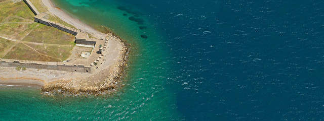 Aerial drone ultra wide photo of famous castle of Rio next to famous cable bridge of Harilaos...