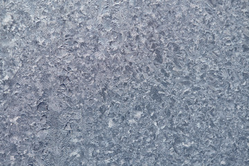 Texture of Frozen drops of condensed steam water drops on the transparent window glass. Clean background. Water vapor condenses on cold window glass and freezes into ice