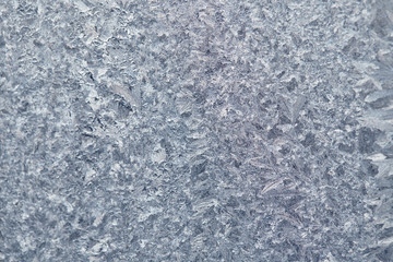 Frozen drops of condensed steam water drops on the transparent window glass. Clean background. Condensation of moisture at extreme temperatures. Water vapor condenses on cold window glass and freezes
