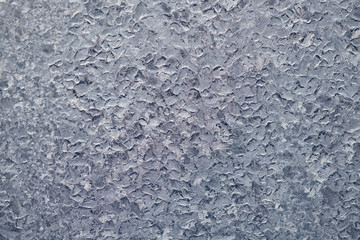 Texture of Frozen drops of condensed steam water drops on the transparent window glass. Clean background. Water vapor condenses on cold window glass and freezes into ice