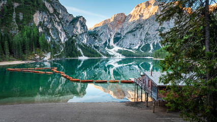 Old hut and Lago di Braies in Dolomites, Italy