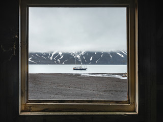 view to yacht through window in cloudy day