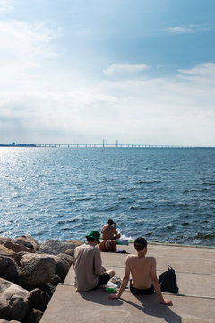 People sunbathing on the promenade in Malmo, Sweden