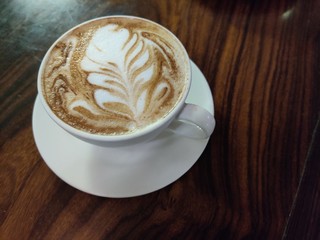 cup of coffee with cream on white background
