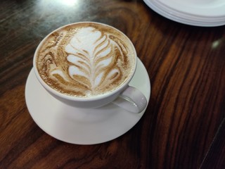 cup of coffee with cream on a background