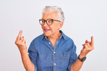 Senior grey-haired woman wearing denim shirt and glasses over isolated white background Showing...