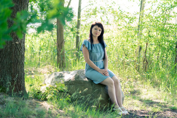 Portrait of a woman with long hair on a background of nature.