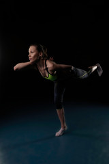 Fototapeta na wymiar girl in sportswear is engaged in yoga in a certain position