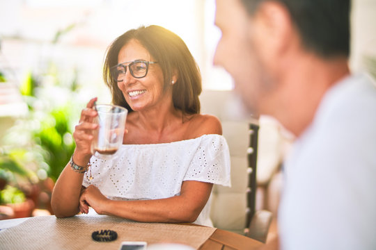 Middle Age Beautiful Couple Sitting On Terrace Drinking Cup Of Coffe