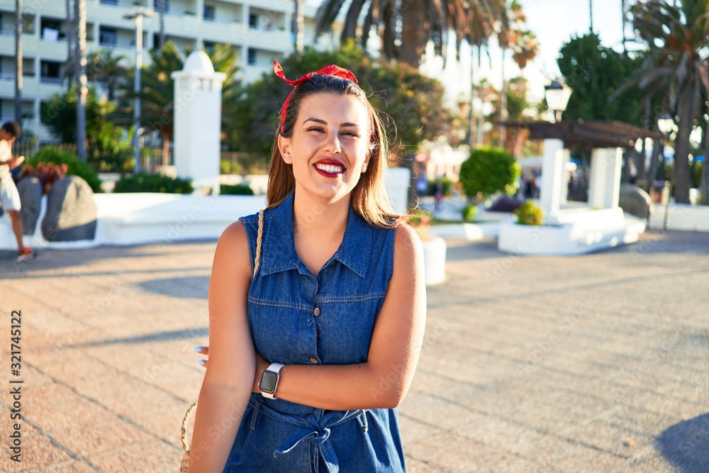 Wall mural Young beautiful woman smiling happy walking on city streets of Puerto de la Cruz, Tenerife on a sunny day of summer