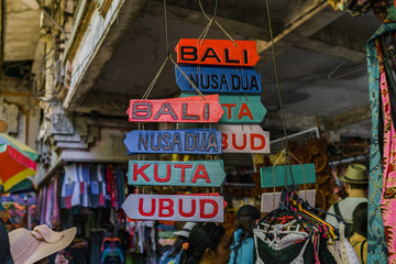 Regional signboards are sold as souvenirs in the Ubud traditional market.