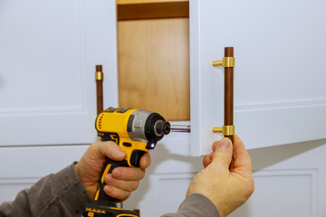 Master drills the cabinet door in the cabinet door