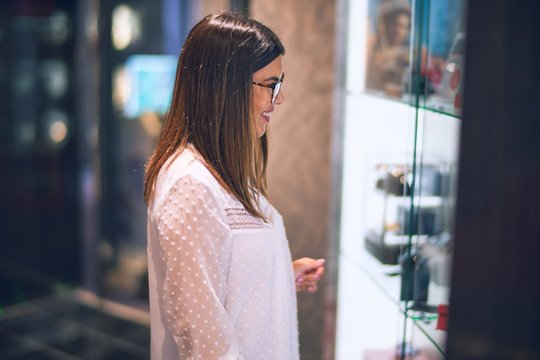 Young beautiful woman on vacation smiling happy and confident. Standing on a deck of ship with smile on face doing a cruise
